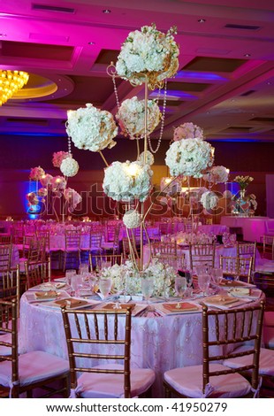 Elegant wedding guest table set for an event with candles lit