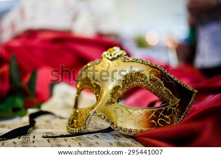 Female carnival mask laying on music sheet (close-up)