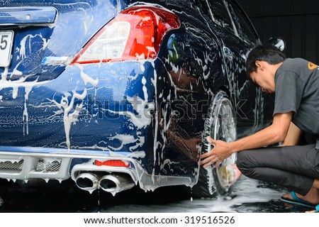 Bangkok, Thailand - June 28, 2015 : Blue car washing by hand using a foam preparation for polishing.