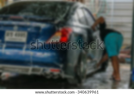 Blurred of Blue car washing by hand using a foam preparation for polishing.