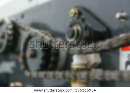 Blurred of Sprocket chain on sheet offset machine draws paper in printery
