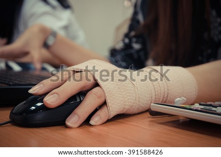 Asian women hand sore working on her computer , process in vintage style