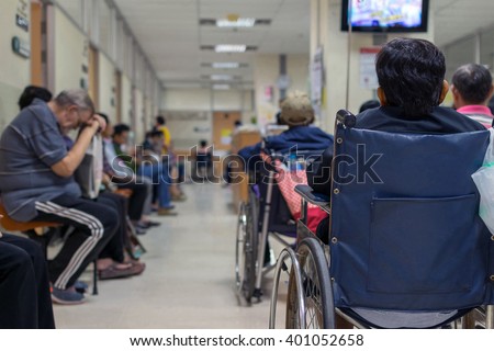 Patient elderly on wheelchair and many patient waiting a doctor and nurse in hospital