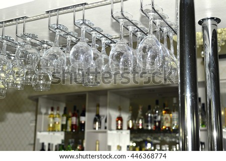 A number of washed glasses hung to dry in the bar.