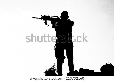Kid with toy machine gun play war on white nature sky background. Children silhouette in black-white. NO WAR!