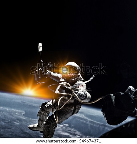 Astronaut on space mission with sun and earth on the background. Elements of this image furnished by NASA.