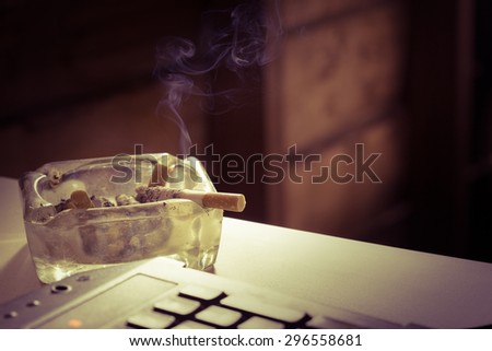 Still life cigarette and glass ashtray. Some man like smoking in work time for make idea.