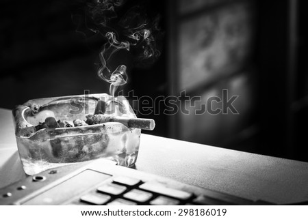 Still life cigarette and glass ashtray. Some man like smoking in work time for make idea.