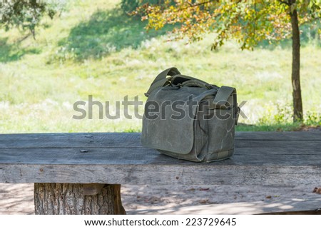 Strong cotton bag for photo stuff isolated on a table in forest