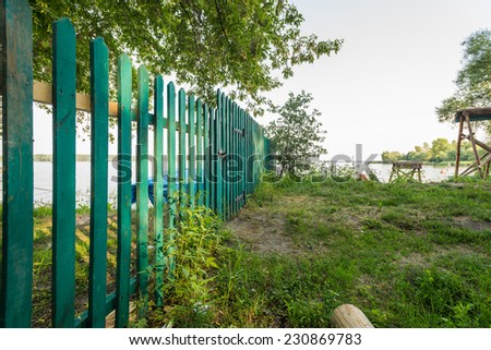 Wood green fence of riverside house