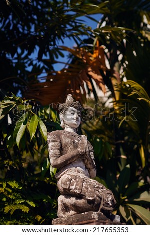 Statue of a demon on the walls of a Buddhist temple. Thailand.