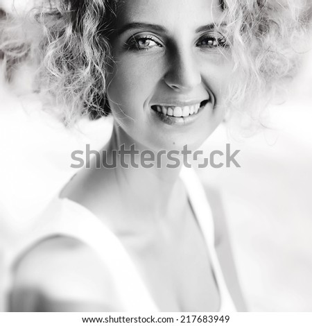 Young happy laughing girl on the street.Black and white portrait.