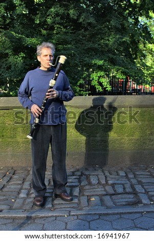 Male playing the flute on the street