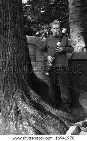 Male playing the flute on the street