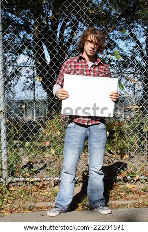 Young male holding a blank sign - just put your own message.