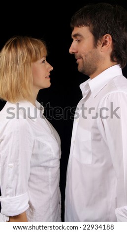Married couple dressed in white shirts, black background