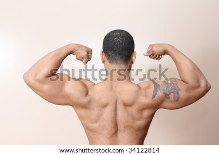 stock photo : Young male flexing back and arm muscles