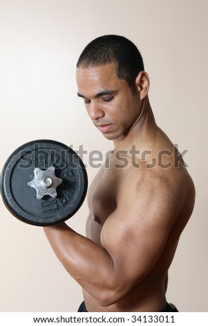 stock photo Young body builder lifting weights