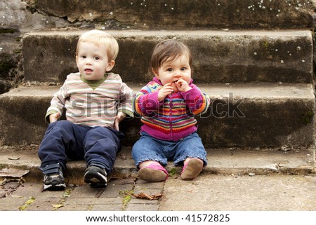 Two Young Children Hanging out on Stair Steps