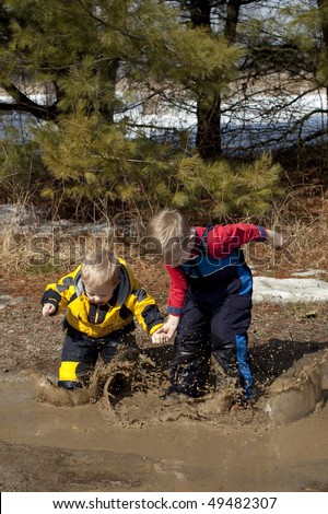 Boys Playing and Splashing in a Mud Puddle