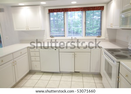 Wide Angle View of Well Lit Beautiful White Kitchen