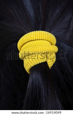 Woman coiffure with yellow hairpin
