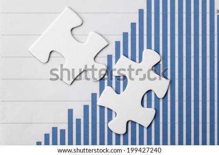 Puzzle pieces on graph.Business solution concept