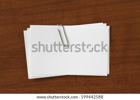 Stack of Blank Cards with paper Clip. on Wood Desk