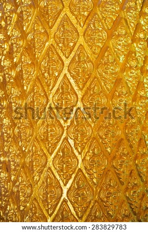 Golden angels pattern on the pillars of Phra That Nongbua Pagoda, Ubon Ratchathani, Thailand