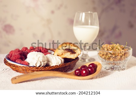 Healthy breakfast with milk and croissants. Fresh tasty berries and marshmallows. Vintage toning. Copy space.