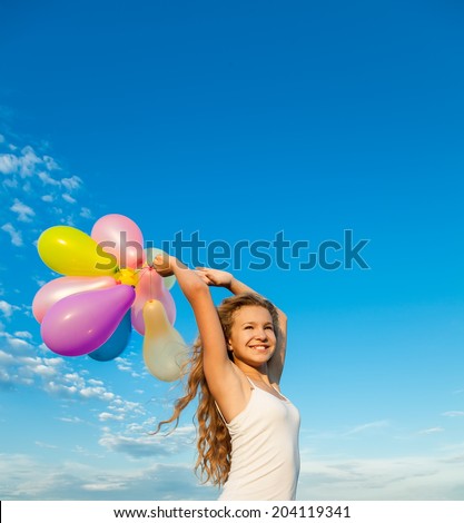 summer holidays, celebration, family, children and people concept - happy blond girl with colorful balloons over blue sky