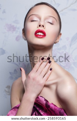 Glamour woman in fashion dress and professional make up over vintage flower background.