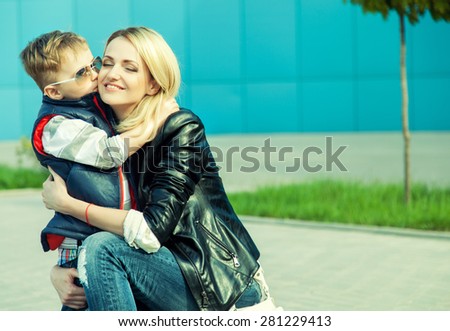 happy family concept. Son kissing his beautiful mother.