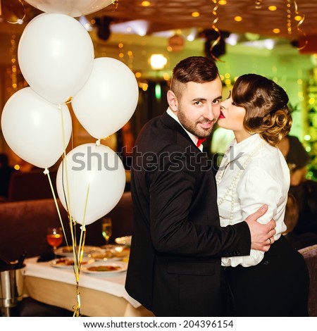 Portrait of happy and lovely elegant couple in restaurant. Stylish clothing and perfect haircut
