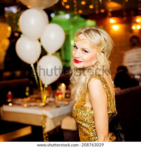 Party people concept. Emotive portrait of happy and young woman in restaurant. Stylish clothing and perfect hair. Indoor shot