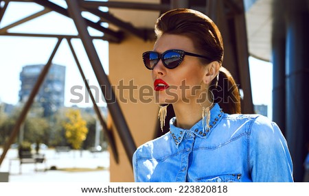 Fashion portrait of young beautiful and sexy brunette girl in trendy casual clothes. Vogue style. Outdoor shot. Street fashion concept