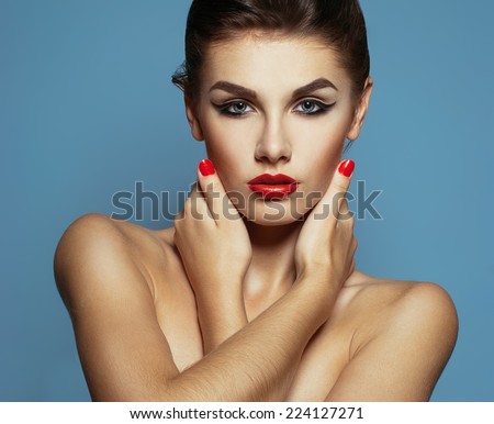 High fashion look. Portrait of a fashionable model with sexy red lips, beautiful naked shoulders and perfect skin. Close up. Studio shot