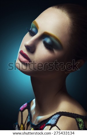 Close up portrait of beautiful female face with colorful make up.Beauty. Fresh glowing skin. .Blue.Art.Theater.Face art.Bright. Look Fashion make up. Fantastic Modern production
