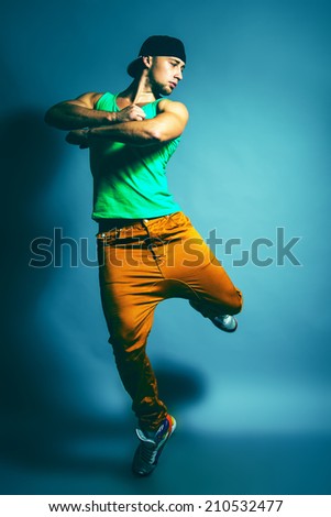 Portrait Of Young Handsome Man Showing Break Dance Movement In