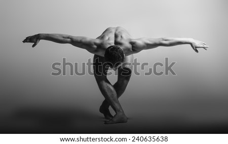 Dance freedom concept. Young handsome ballet man in grace pose. Perfect hair & skin. Close up. Studio shot