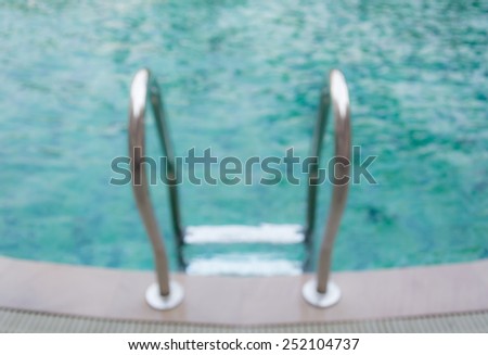 Grab bars ladder in the pool.Blur for background