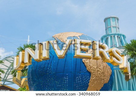 SINGAPORE - JULY 20: Tourists and theme park visitors taking pictures of the large rotating globe fountain in front of Universal Studios.