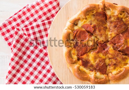 Homemade Pepperoni Pizza on wood plate -Unhealthy and Junk food