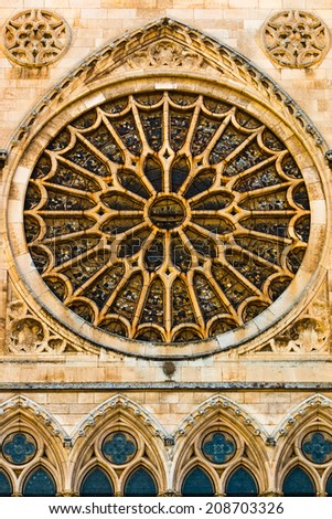 View of the entrance rose window, stained glasses and lancet archs shapes in the gothic cathedral of Leon, Spain