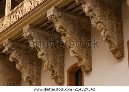 original corbel decoration in La Salina Palace courtyard with twisted carved bodies in Salamanca Spain