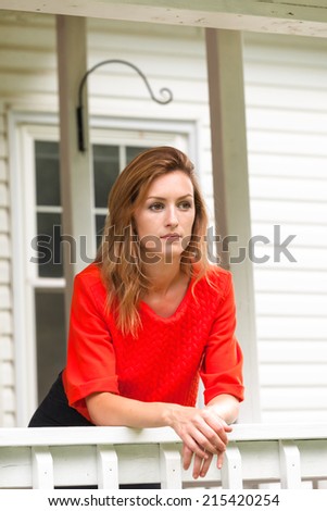 Beautiful young woman leaning on rail white veranda
