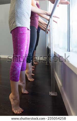 Young women doing barre exercises Young women doing barre exercises