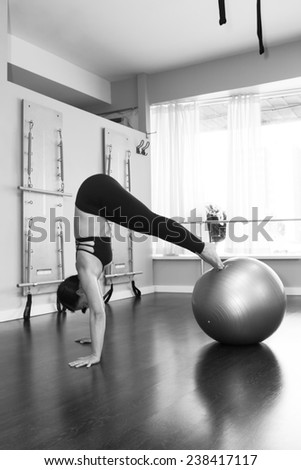 Beautiful woman doing pike up with stability ball