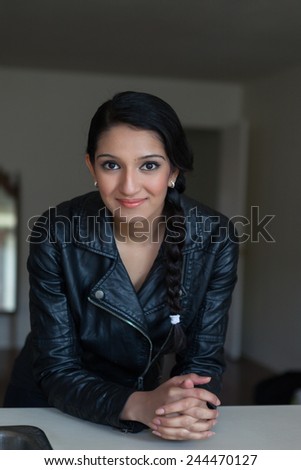Gorgeous young stylish woman with long dark hair and dark eyes posing in urban loft