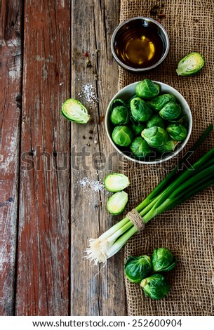 Fresh green Bruxelles sprouts on a Wooden Background. Vegetarian food, health or cooking concept. Top view.